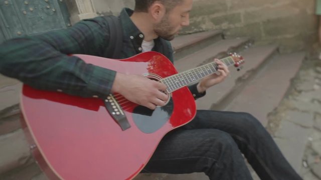 Lovely young street musician with guitar