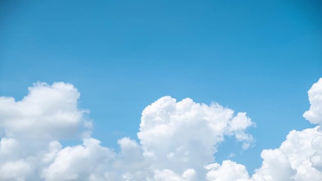 Dramatic cumulonimbus storm clouds bubbling up in the blue sky. Time lapse