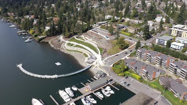 Aerial / drone footage of Meydenbauer Bay Park, beach park, marinas with opulent waterfront luxury villas in Belleview, near Seattle, Washington during the COVID-19 pandemic