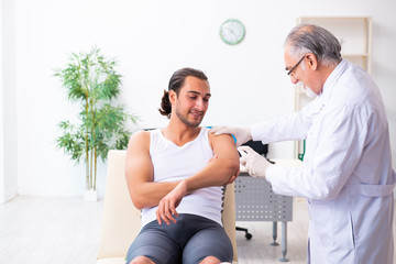 Fototapeta premium Young male patient visiting experienced doctor