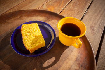 Delicious slice of corn cake with guava syrup accompanied with a cup of coffee