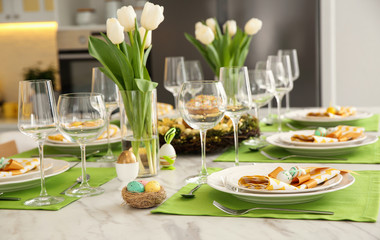 Festive Easter table setting with floral decor in kitchen