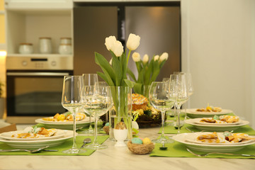 Festive Easter table setting with floral decor in kitchen