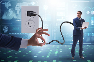 Businessman being powered by electricity and plug