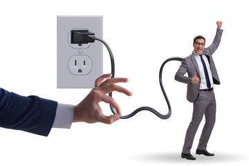 Businessman being powered by electricity and plug