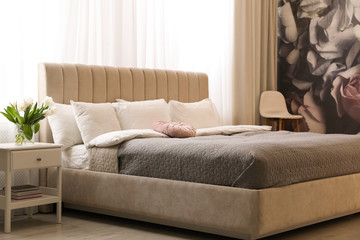 Beautiful room interior with large comfortable bed