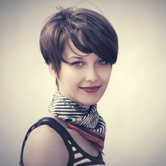 Happy young fashion woman in tank top and silk scarf outdoor