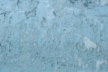 Fototapeta na wymiar Surface Of Concrete Wall With Stains And Streaks Of Blue And White Paint, Cracks And Roughness. Grunge Background For Design.