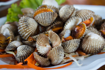 Cooked clams are served on a plate. Very tasty in Thailand