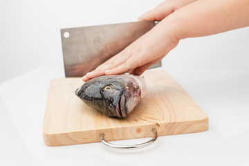Tilapia is a eviscerated fish with a knife.