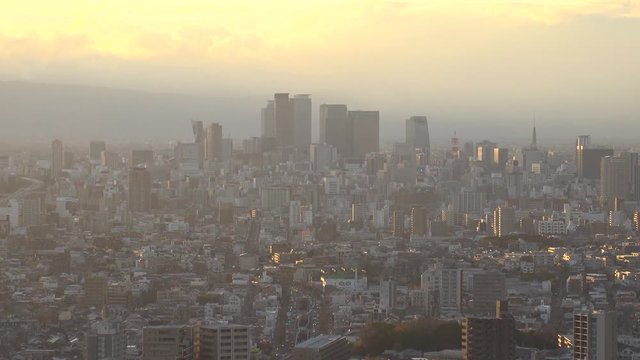 NAGOYA, AICHI, JAPAN - FEB 2020 : Aerial high angle view of cityscape of Nagoya city. View of buildings and street traffic around central downtown area. Time lapse shot sunset to night.