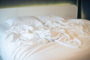Mattresses blanket and pillows on the luxury bed in the hotel room after a restful sleep.
