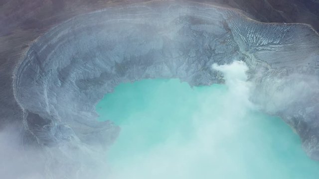 View from above, stunning aerial view of the Ijen volcano with the turquoise-coloured acidic crater lake during a beautiful sunrise. East Java, Indonesia.
