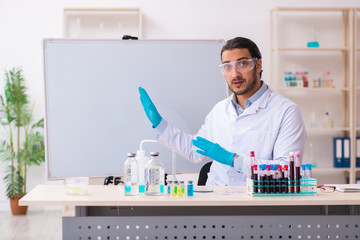 Young male chemist working in the lab