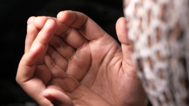 muslim women with head scarf praying, close up 