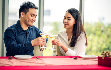 Romantic young happy couple relax talking and drinking wine glasses celebrate together in the restaurant