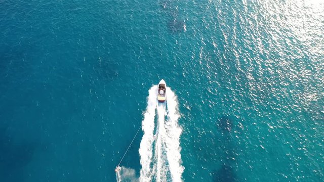 Aerial view of a motor boat towing a water skier. Elounda, Crete, Greece