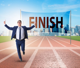 Businessman on the finishing line in competition concept