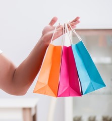 Young man with gift bag at home preparing suprise for wife