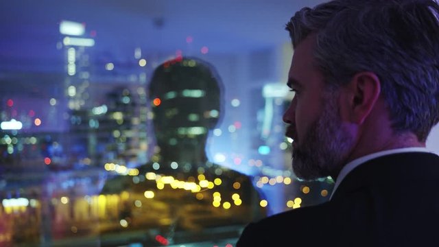 Bearded handsome businessman adult contemplating business cityscape out of window thinking over future ideas creating. Close-up. Concept for ambitions.