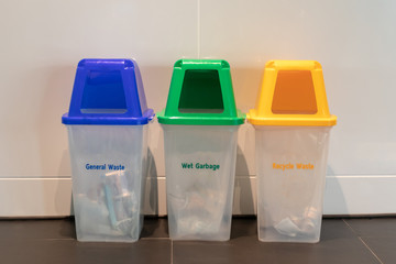 Three garbage on grey background