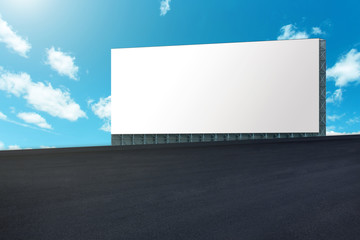 Large billboard on road with blue sky