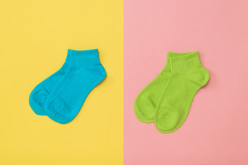 Multi-colored sports socks on a multi-colored background. Flat lay.