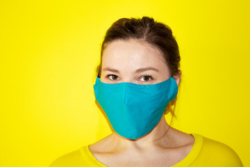  Girl with blue mask on face against Coronavirus Disease. Safe and Protection concept. COVID-19 Pandemic Coronavirus Woman  wearing face mask protective for spreading of disease virus .