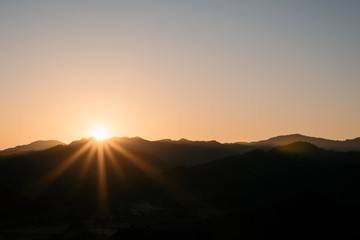 Silhouette of mountain and the sun and sky,landscape background.