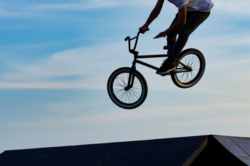 BMX bicycle + jump off ramp