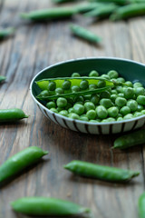 Fresh Green Peas and pods on wood table