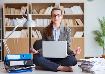 Businesswoman meditating in the office
