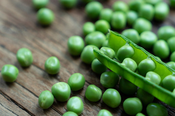 Fresh Green Peas and pods on wood table