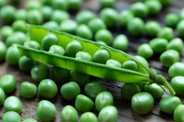 Fresh Green Peas and pods on wood table