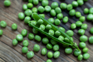 Fresh Green Peas and pods on wood table