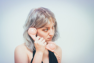 Woman Talking On Landline Telephone, Indoors