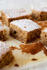 Homemade Tasty Applesauce Cake on a white plate, side view. Close-up.