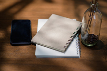 Notebook and pen placed on a wooden table.working at home concept .