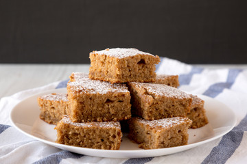 Homemade Applesauce Cake on a white plate, side view. Close-up.