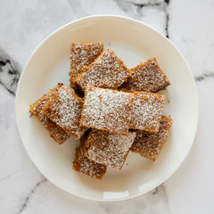 Homemade Tasty Applesauce Cake on a white plate, top view. Flat lay, from above, overhead.