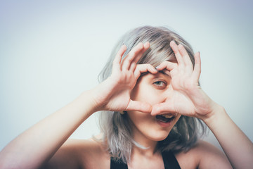 woman making a hand heart frame