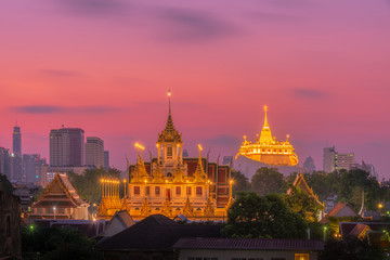 Fototapeta premium Loha Prasat Wat Ratchanatda and Golden Mountain pagoda during sunrise in Bangkok, Thailand.