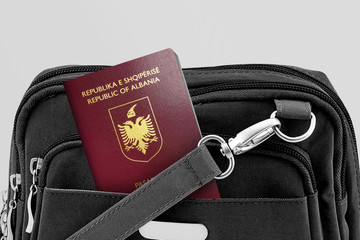 Close up of Albania Passport in Black Travel Bag Pocket