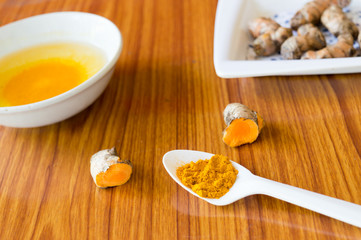 A table spoon of Pure Turmeric Haldi Spices Powder. Turmeric with Water. Concept of detox or detoxification. Health care and medical nutrition supplement. Ayurveda Home remedies. Health and Spa. India