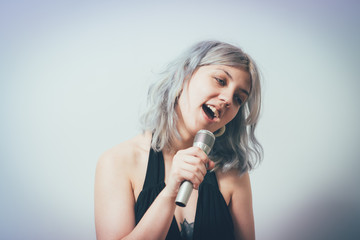 Young girl singing with microphone