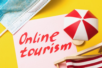 Fototapeta premium Note with text and beach accessories. Concept on the topic of online tourism in a home quarantine environment