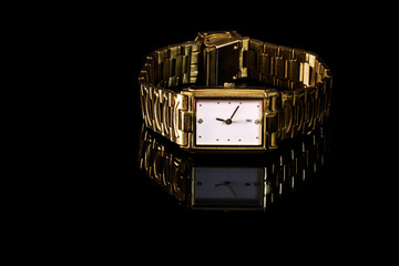 gold plated wrist watch with golden metallic strap
