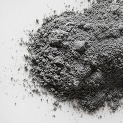 Top view of natural colored gray pigment powder close up. Matt grey eyeshadow or powder pigment on...