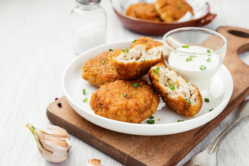 Delicious crispy fried breaded chicken patties with sauce.