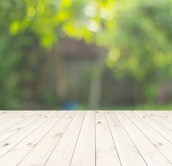 wooden table and green nature background